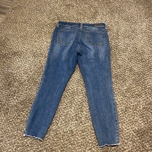 Kut from the Kloth denim blue jeans with frayed edges at the bottom of the legs